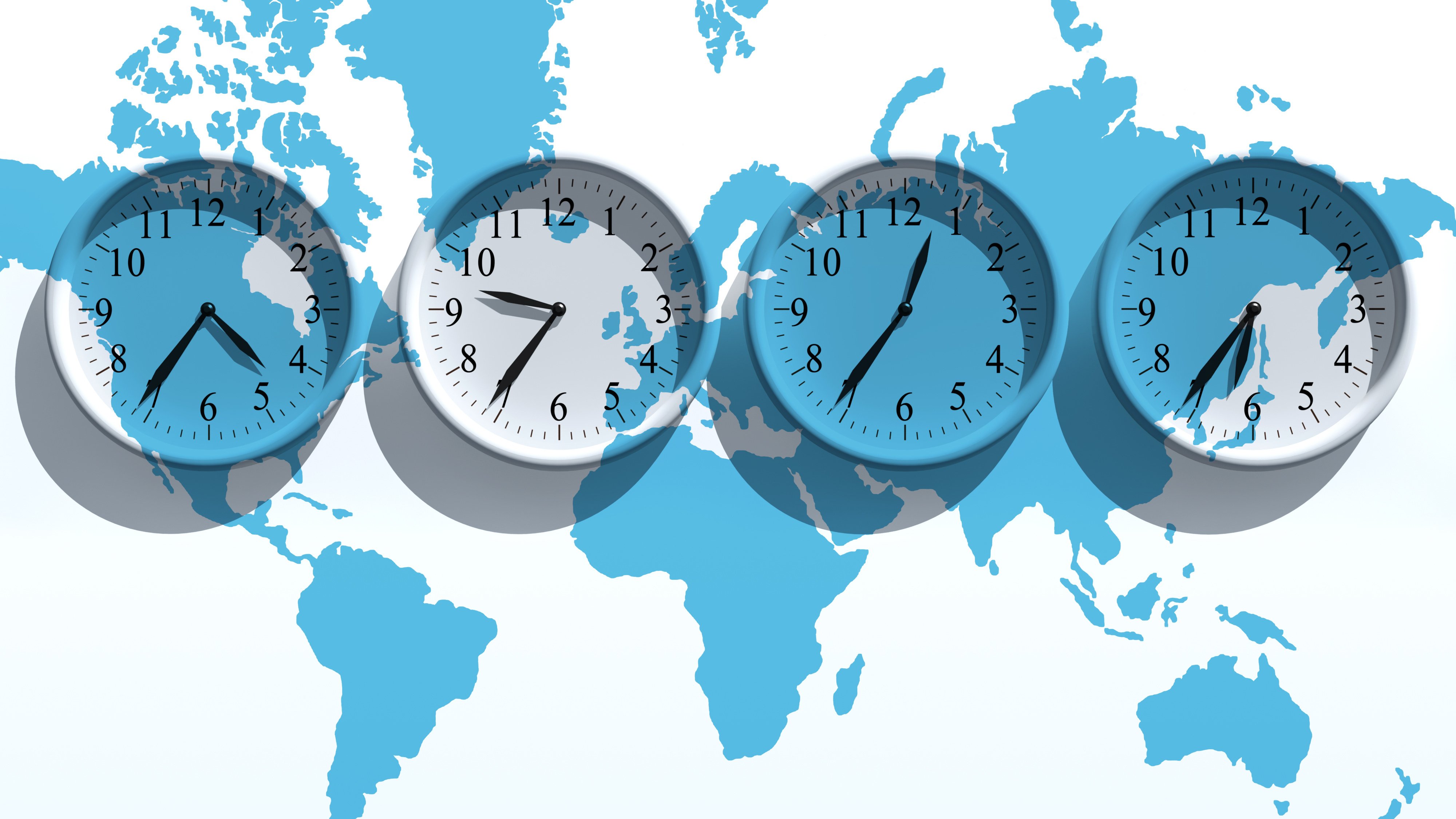 Image of Four clocks and a world map - Showing time across the globe.